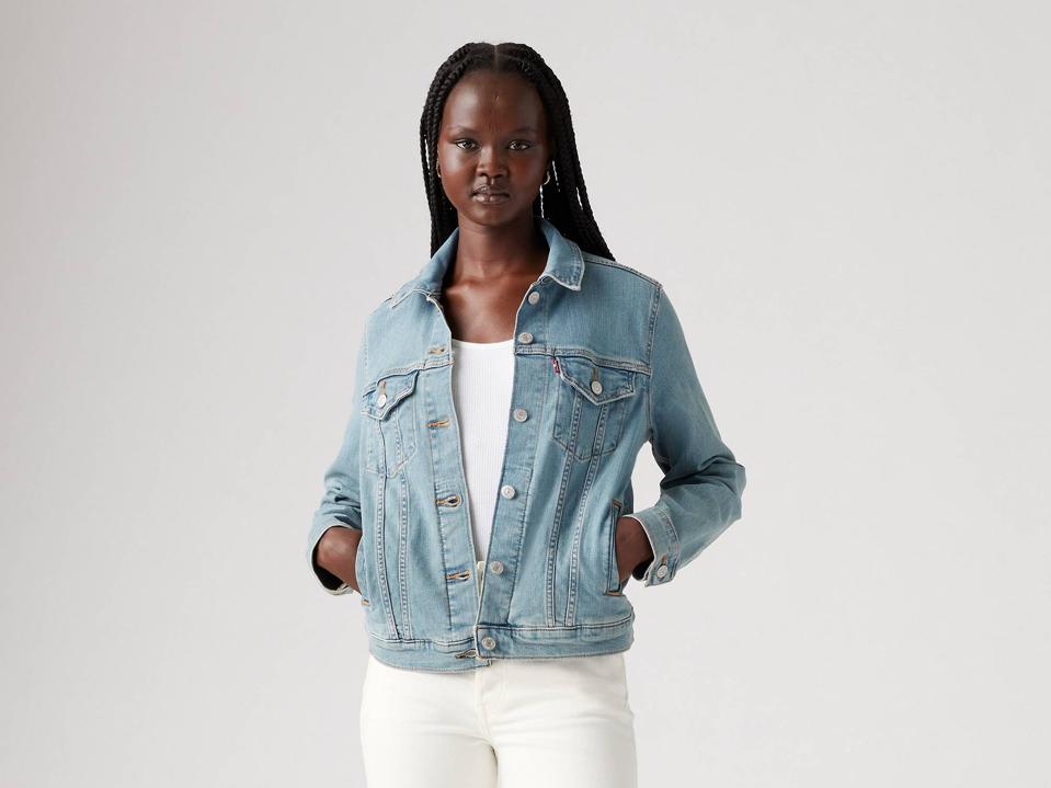 Levi’s Original Trucker Jacket on a model wearing white jeans.