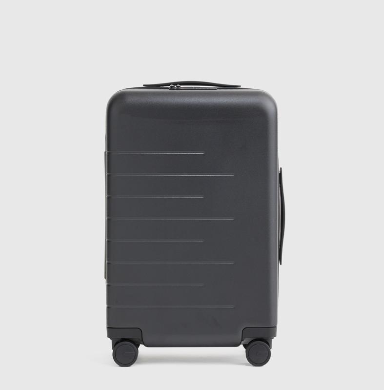 product shot of a black, 20-inch Quince Carry-On Hard Shell Suitcase