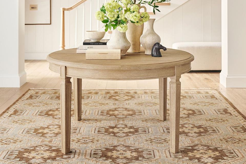 The Sausalito Round Extending Dining Table on a patterned tan run