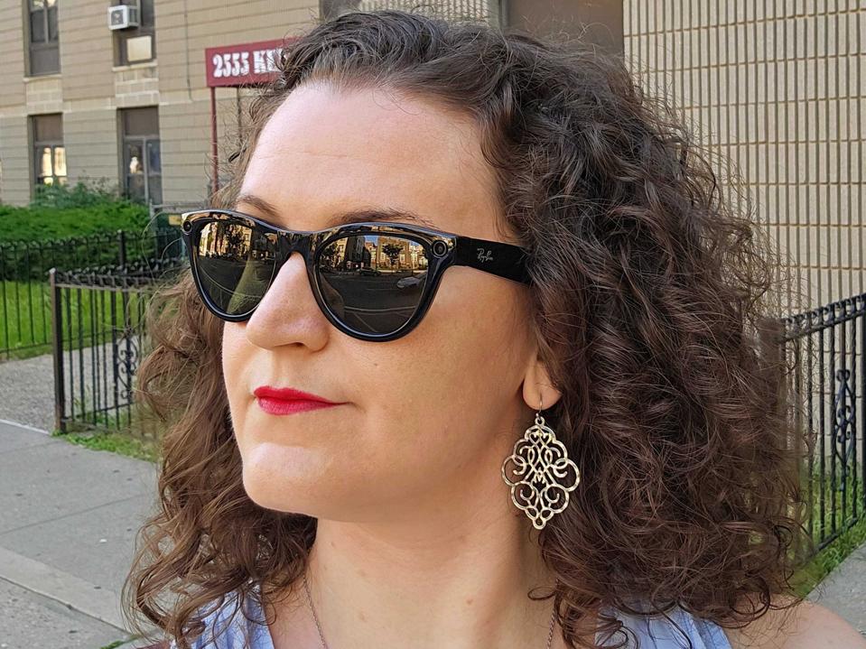 The author wearing a pair of the Ray-Ban Meta smart sunglasses outdoors.