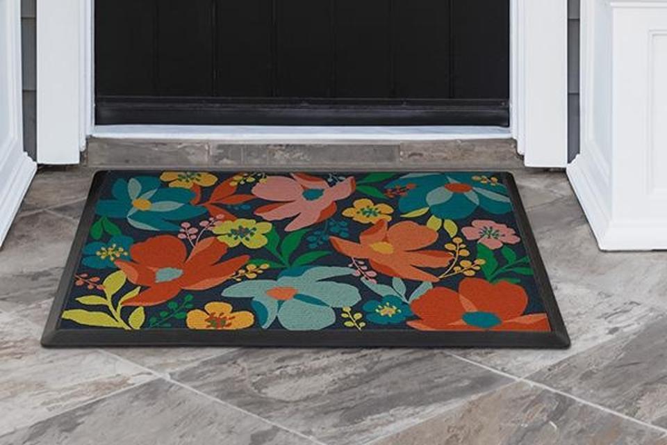 The Ruggable Blossom Multicolor Doormat on a gray tile entryway