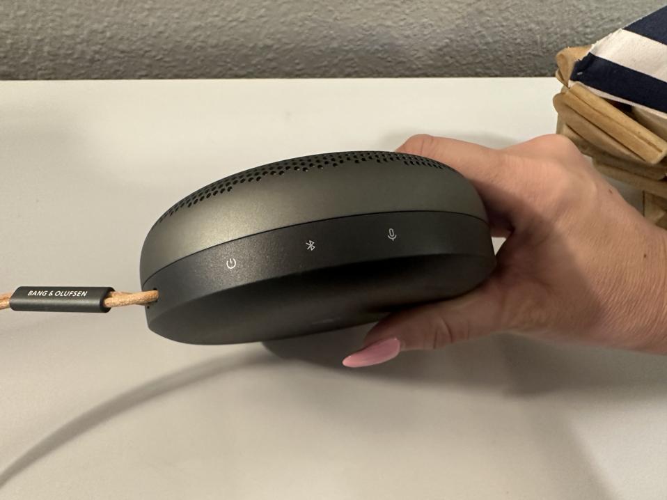 Bang & Olufsen Beosound A1 (2nd Gen) held in a hand.