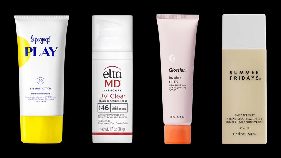 Four sunscreens against black background