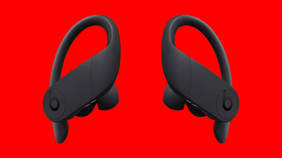 A pair of earbuds on a red background