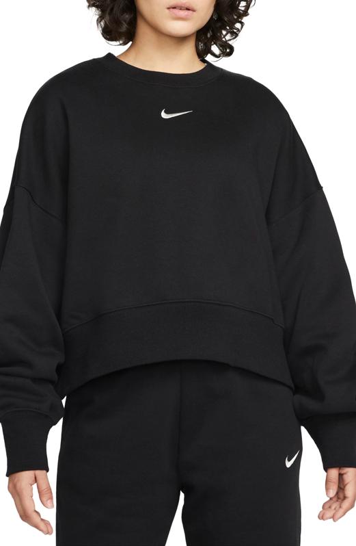 Woman wearing a black Nike Phoenix Fleece Crewneck Sweatshirt.