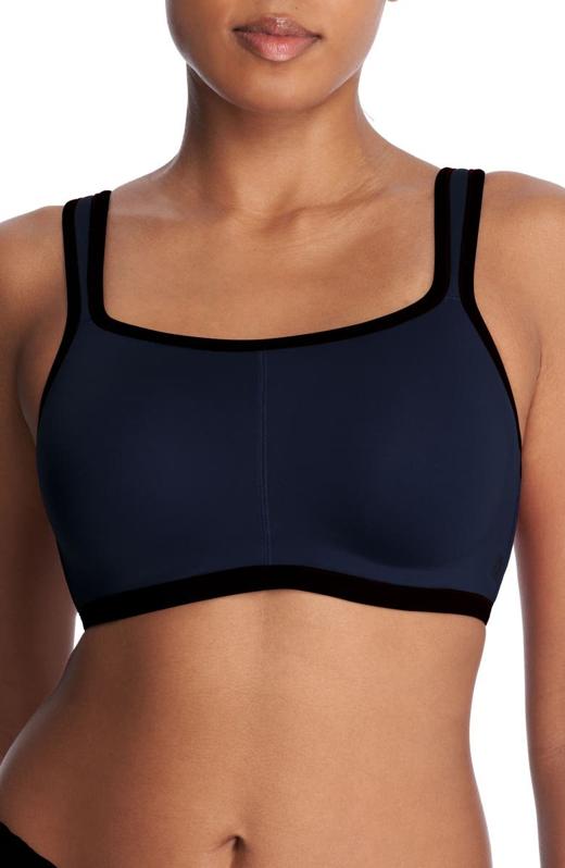 Woman wearing a black Natori Yogi Convertible Sports Bra.