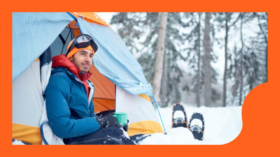 Traveller camping in an evergreen winter forest in Canada.