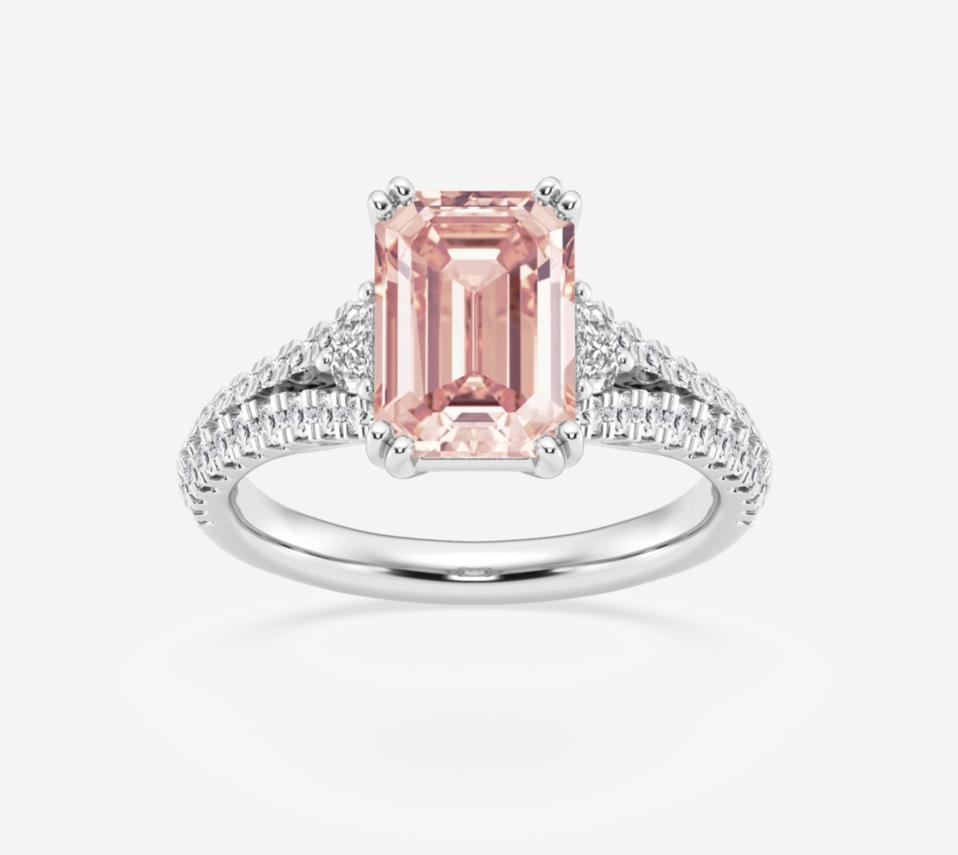 The Pink Emerald Lab Grown Diamond Split Shank Side Stone Engagement Ring against a white background. 