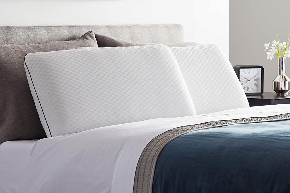 The Weekender Ventilated Gel Memory Foam Pillow photographed on a cozy bed 