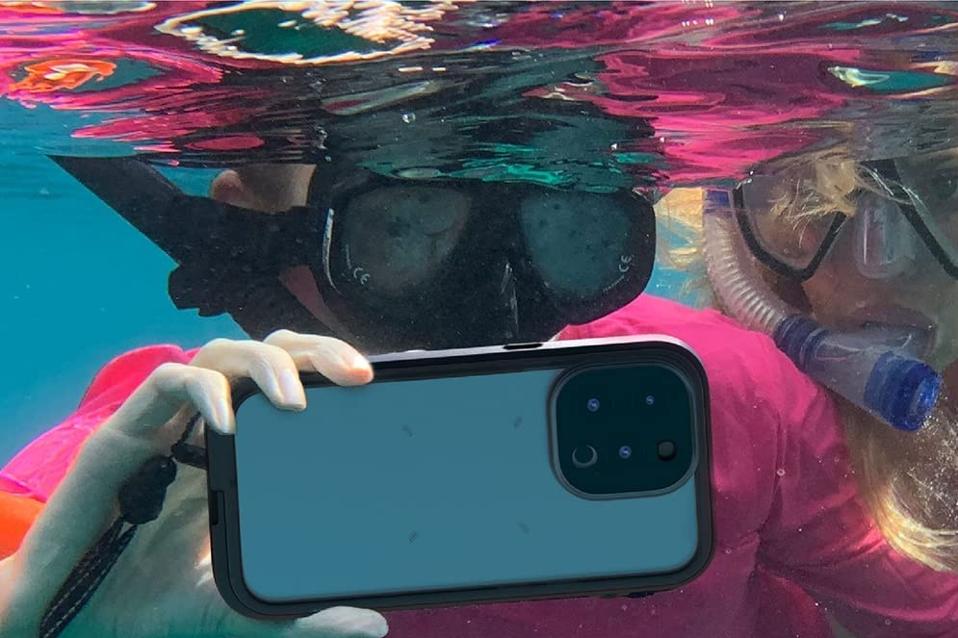 A snorkler using the Catalyst Waterproof Total Protection Case around an iPhone underwater