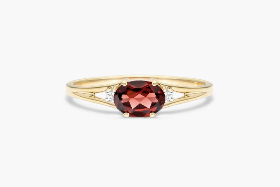 The James Allen Oval Garnet And Diamond Accent Birthstone Ring against a white background. 