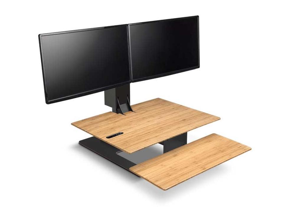 E7 Electric Standing Desk Converter with dual monitors against a white background