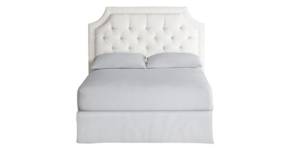 A white lianna headboard from Ethan Allen with a bed up against it