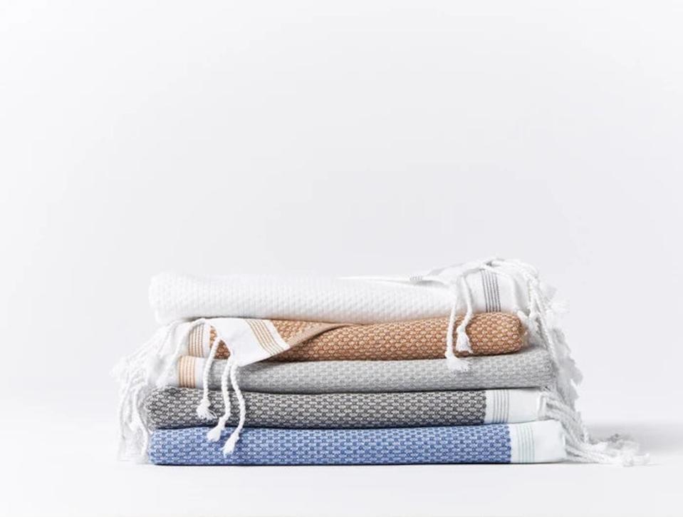 A stacked pile of Coyuchi Turkish Towels against a white background.