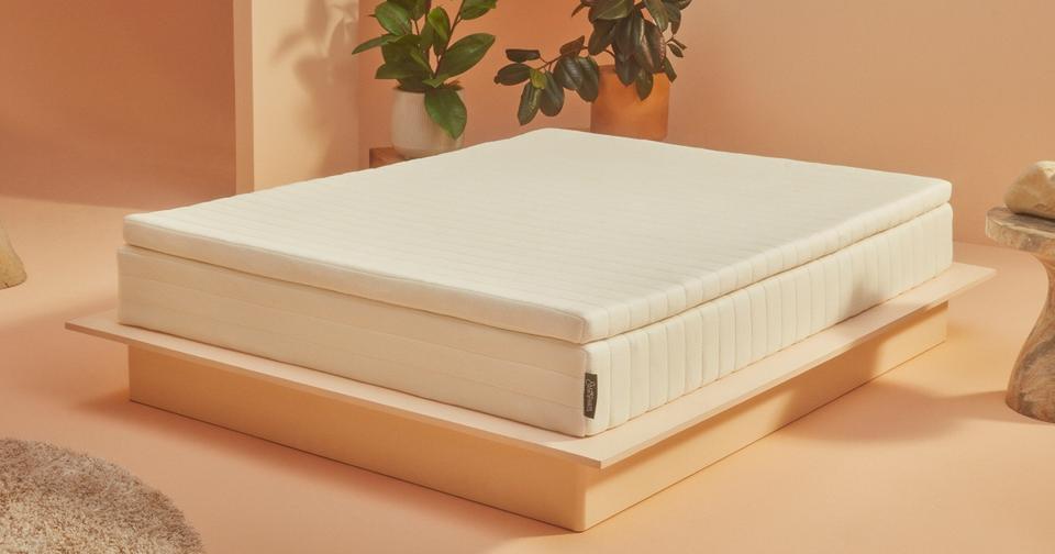 Earthfoam Mattress Topper on a bed frame in a beige room