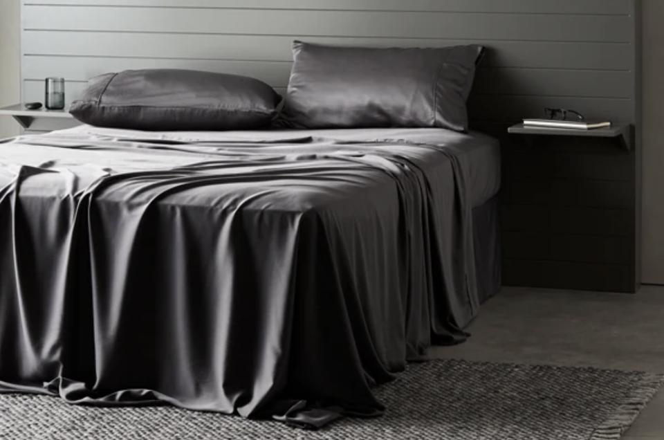 The Ettitude Bamboo Signature Sateen Sheet Set draped over a mattress.