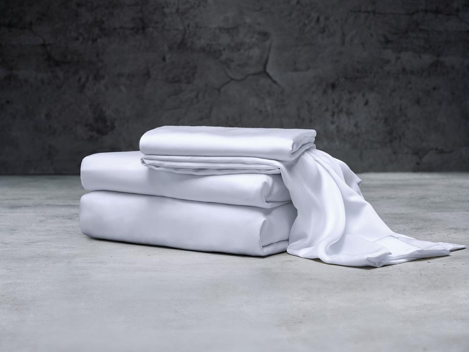 White Luxome Bamboo Sheets folded on a marble countertop