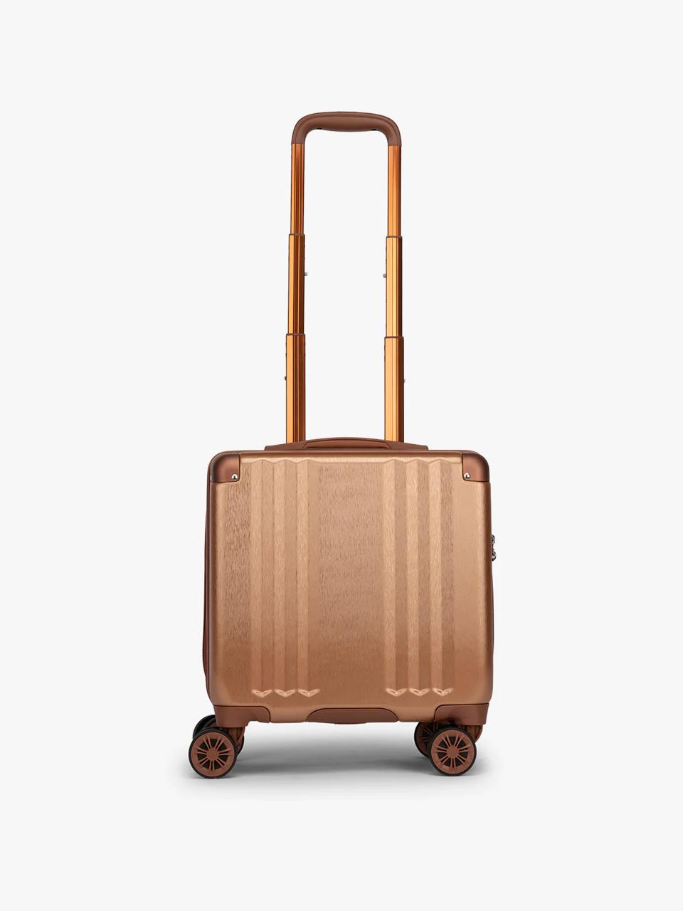 Calpak Ambeur carry-on luggage in rose gold