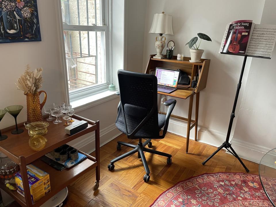 black branch verve office chair facing laptop on small wooden desk in small apartment living room