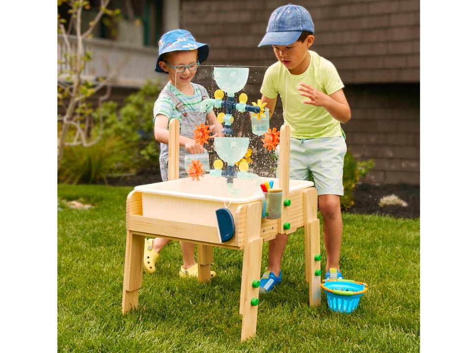 2 big kids playing kiwico Water & Sand Sensory Table outdoors with water