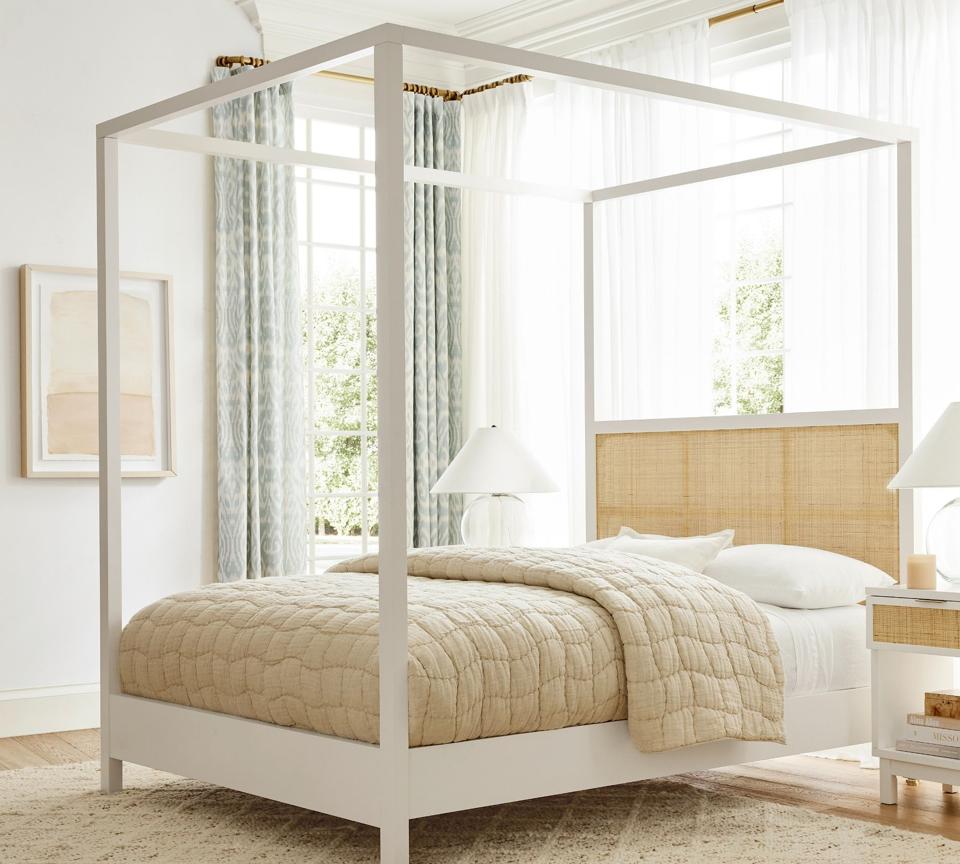 Lifestyle image of the Westly Cane Canopy Bed in a sunny bedroom