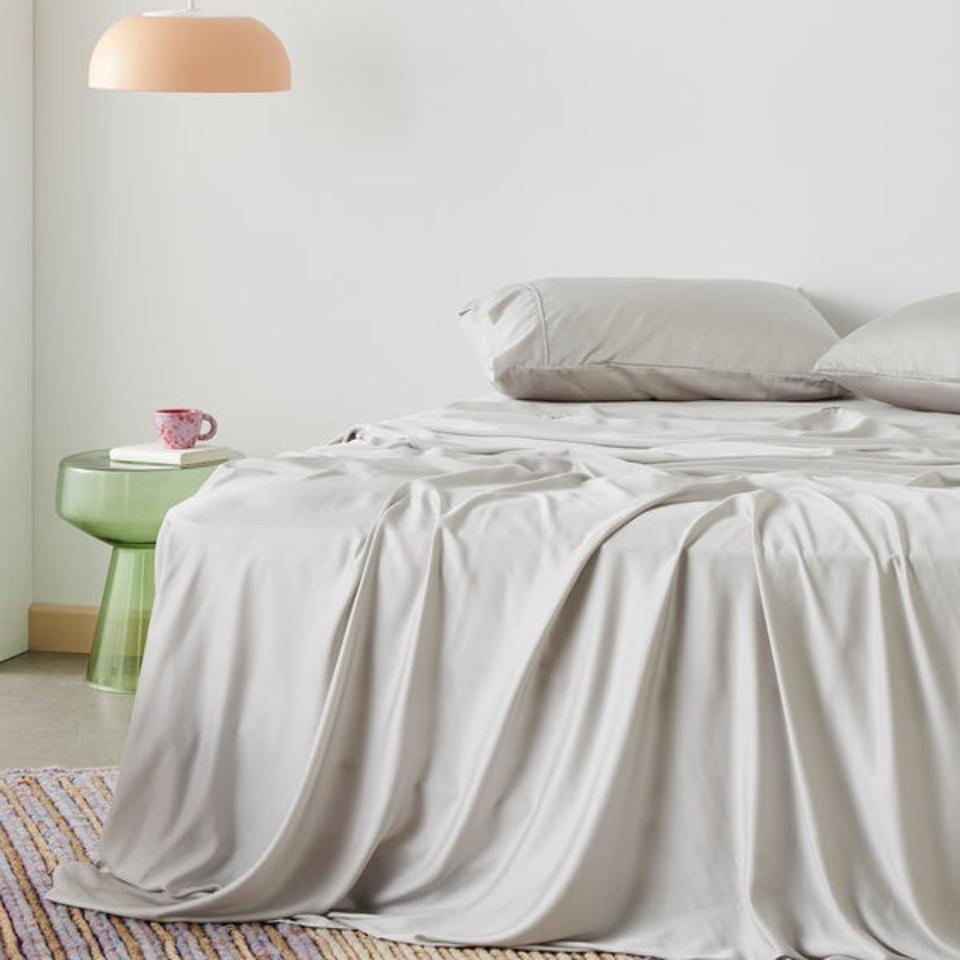 Ettitude Signature Sateen Sheet Set in a light gray in a white bedroom. 