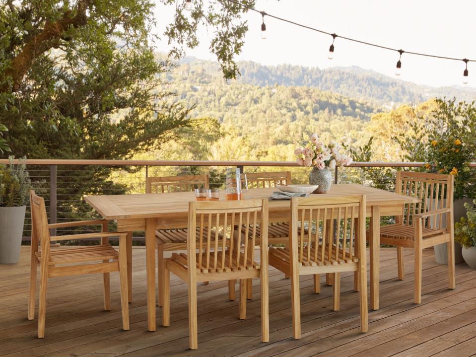 Lifestyle image of the Rejuvenation Anacortes Dining Table and chairs outside.