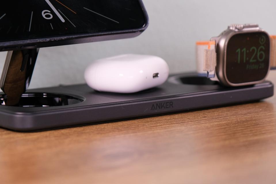 A close up of the charging station with AirPods and an Apple Watch