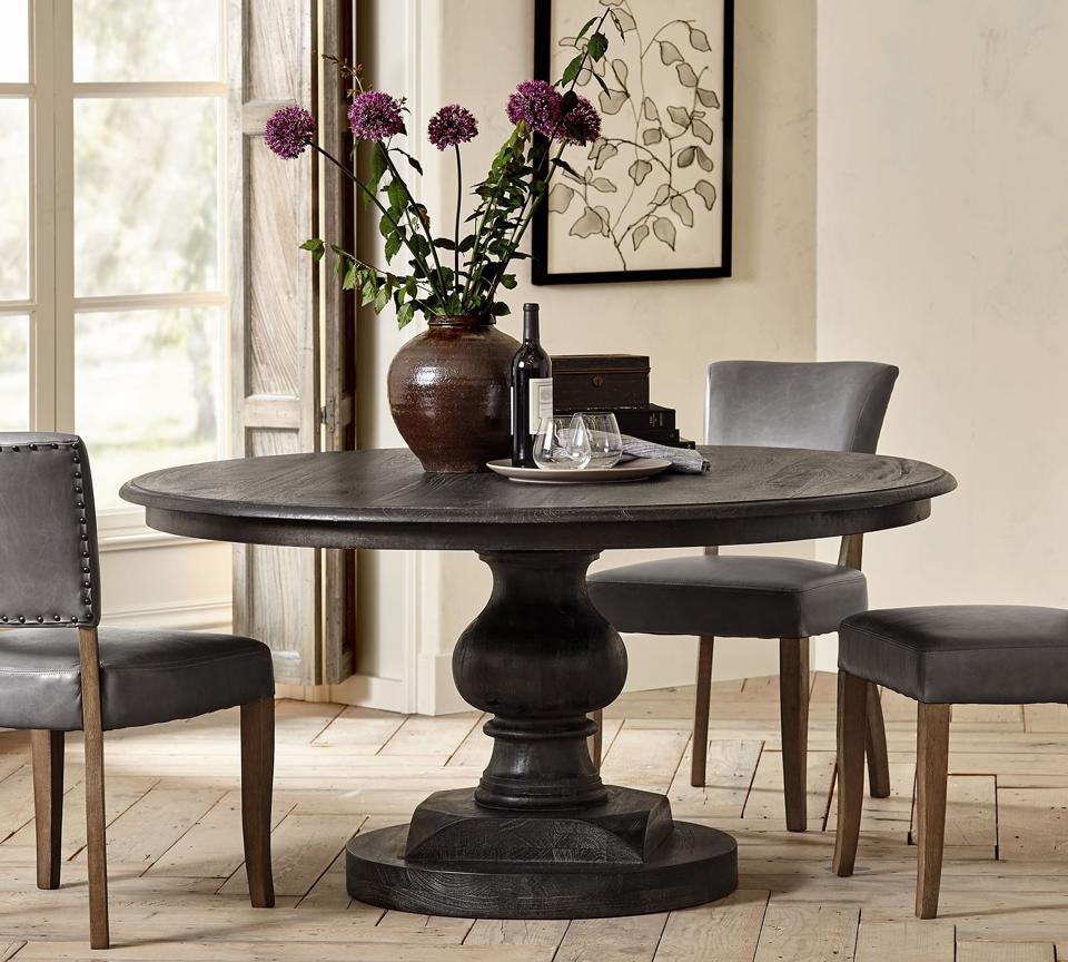 Lifestyle image of the Nolan Round Pedestal Dining Table in a dining room