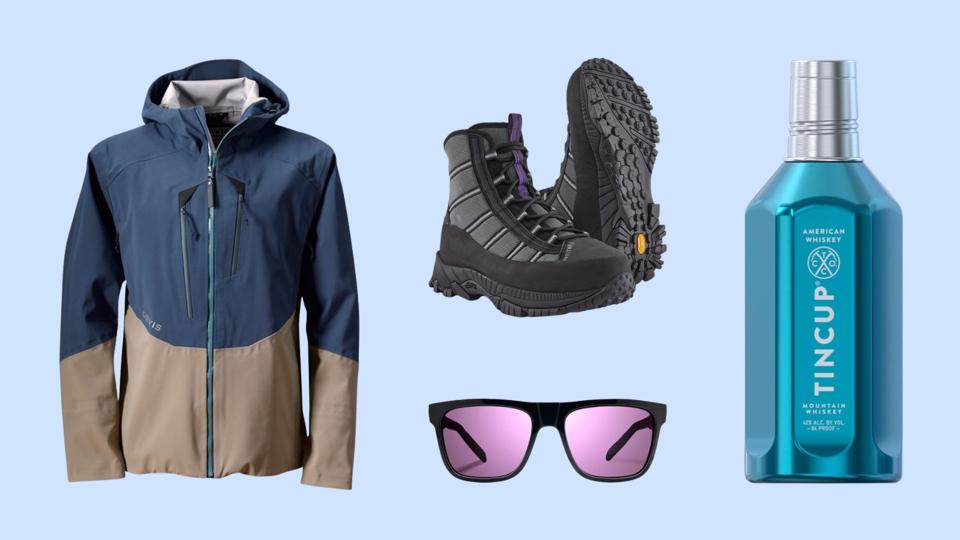 Orvis jacket, Patagonia wading boots, sunglasses and Tincup whiskey on a blue background