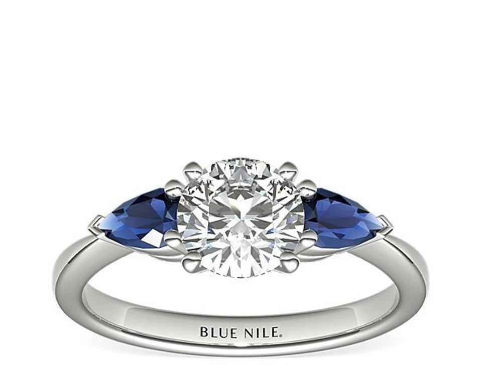 Classic Pear Shaped Sapphire Engagement Ring against a white background. 