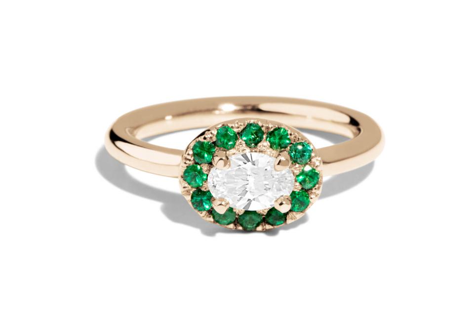 The Bario Neal Dasha Diamond Oval With Emerald Halo Ring against a white background. 