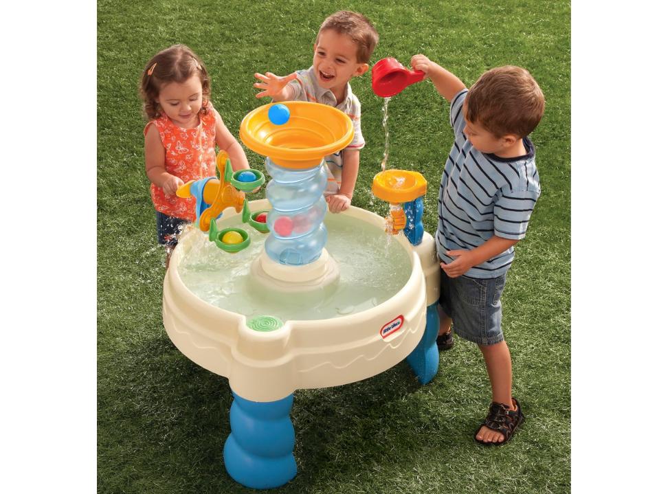 3 toddlers playing with Little Tikes Spiralin' Seas Waterpark Play Table on grass outside