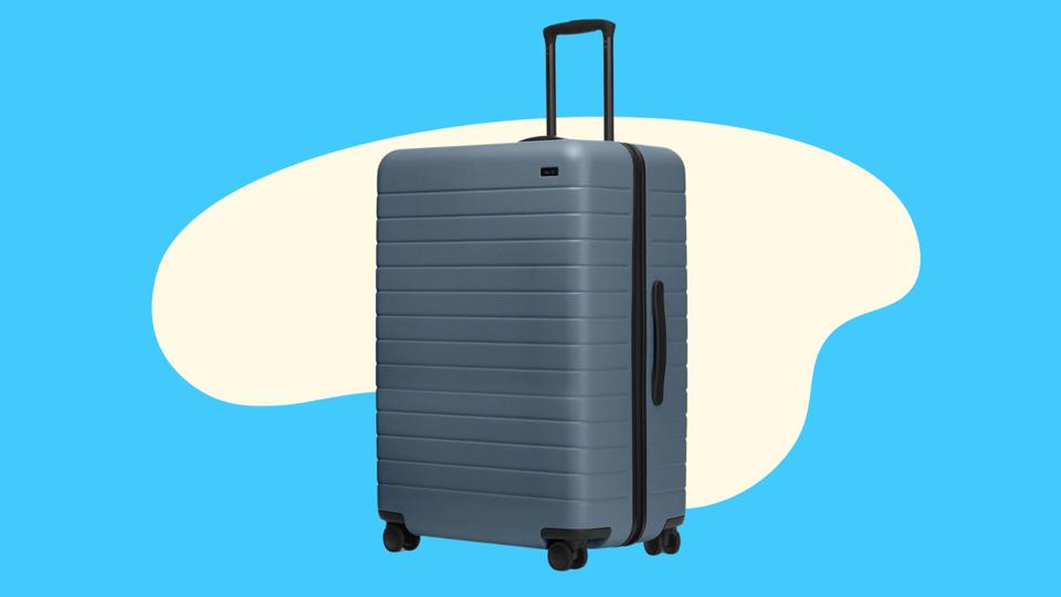 A blue Away suitcase on a light blue abstract background