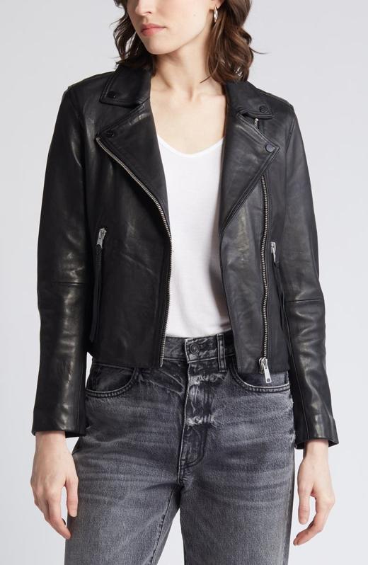 Woman wearing an AllSaints Dalby Leather Biker Jacket and jeans.