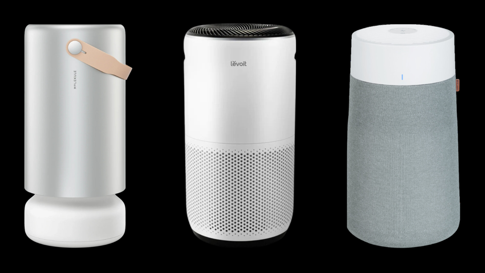 Three air purifiers against black background