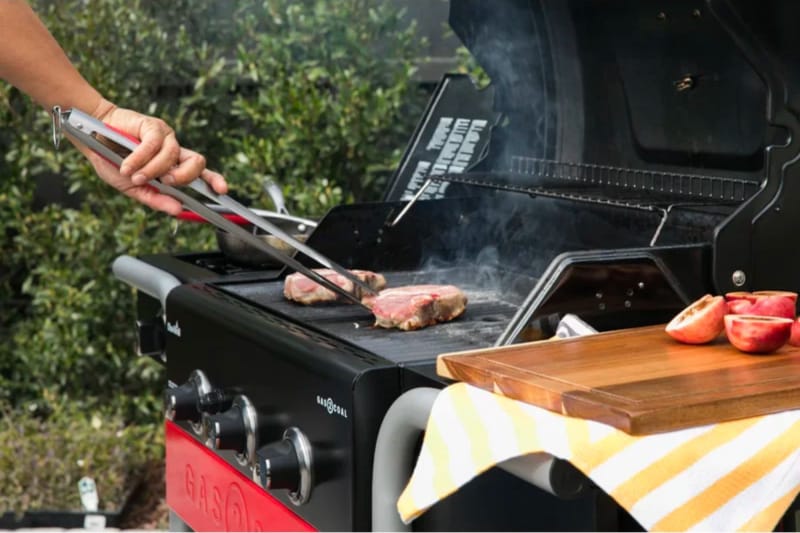 Un maître du gril transforme un steak en train de cuire sur la meilleure option de gril hybride