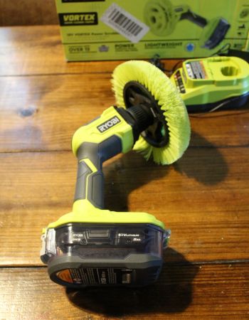 Autolaveuse électrique Ryobi One+ 18 V posée sur le côté sur la table de la cuisine